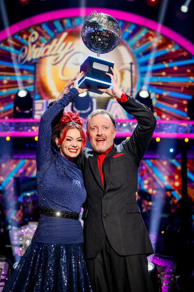 couple holding trophy 