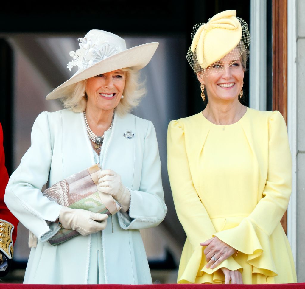 Sophie, Duchess of Edinburgh smiling in yellow beside Queen Camilla