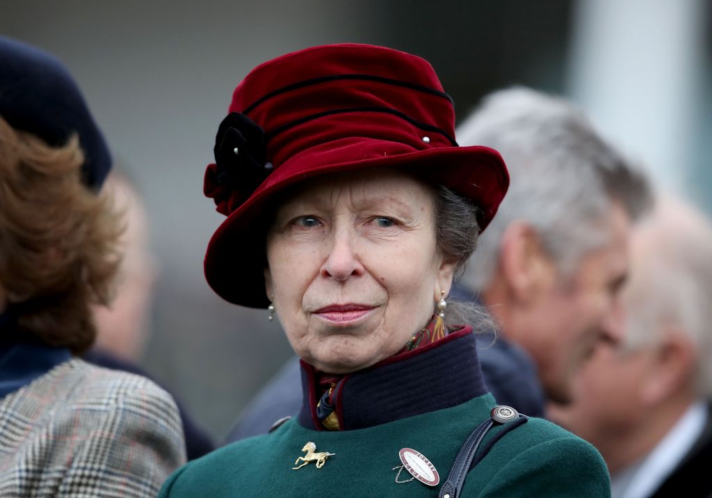 close-up woman in green jacket and red hat