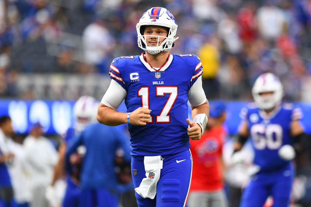 Josh Allen running onto pitch in full football gear