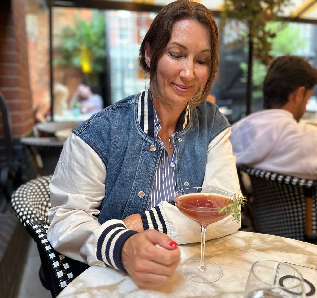 woman holding cocktail in bar 