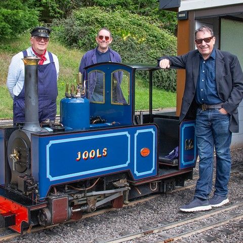 Jools Holland posing with a model railway train