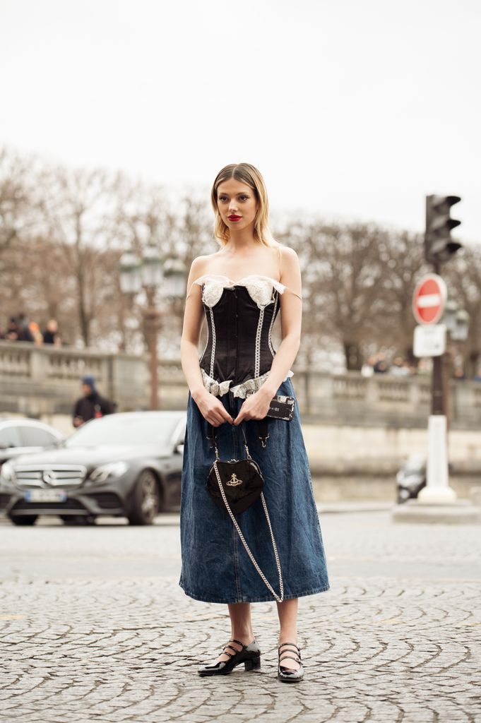 PARIS, FRANCE - MARCH 04: Danielle Marcan seen wearing a complete Vivienne Westwood look with a denim shoulder free corsage, a jeans skirt, black ballet flats and a black heart bag 
 outside the Vivienne Westwood show during Paris Fashion Week - Womenswear Fall Winter 2023 2024 on March 04, 2023 in Paris, France. (Photo by Raimonda Kulikauskiene/Getty Images)