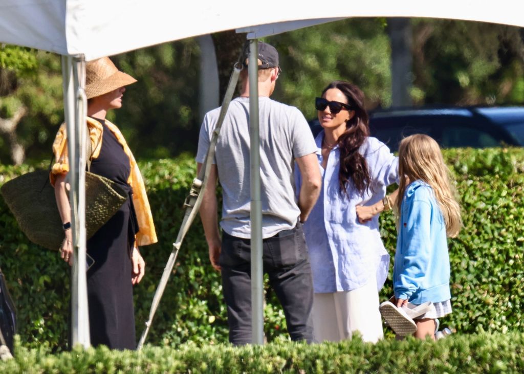 Meghan Markle was snapped wearing Prince Harry's shirt as she visited him whilst he filmed scenes for his new Netflix show at the Royal Salute Polo Challenge in Palm Beach. 