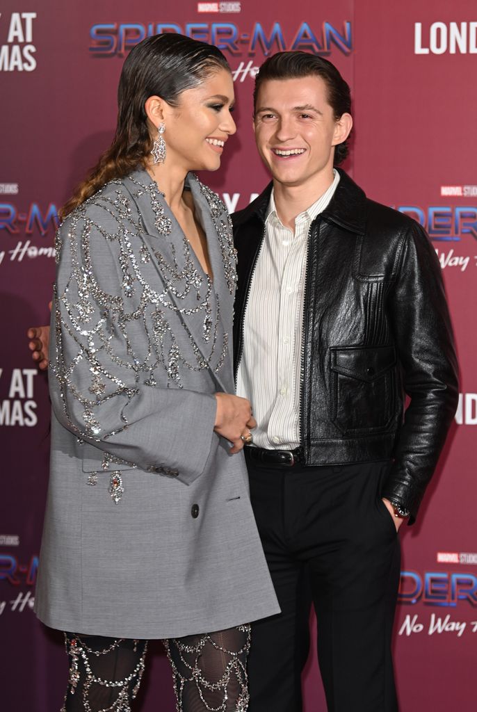 Zendaya and Tom in December 2021 smiling at each other on the red carpet