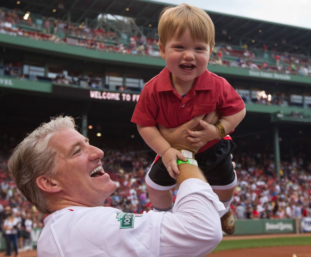 John King, CNN chief national correspondent holding up his son Jonah King, 1, before throwing out the first pitch at a New York Yankees vs Boston Red Sox game at Fenway Park on Saturday, July 7, 2012