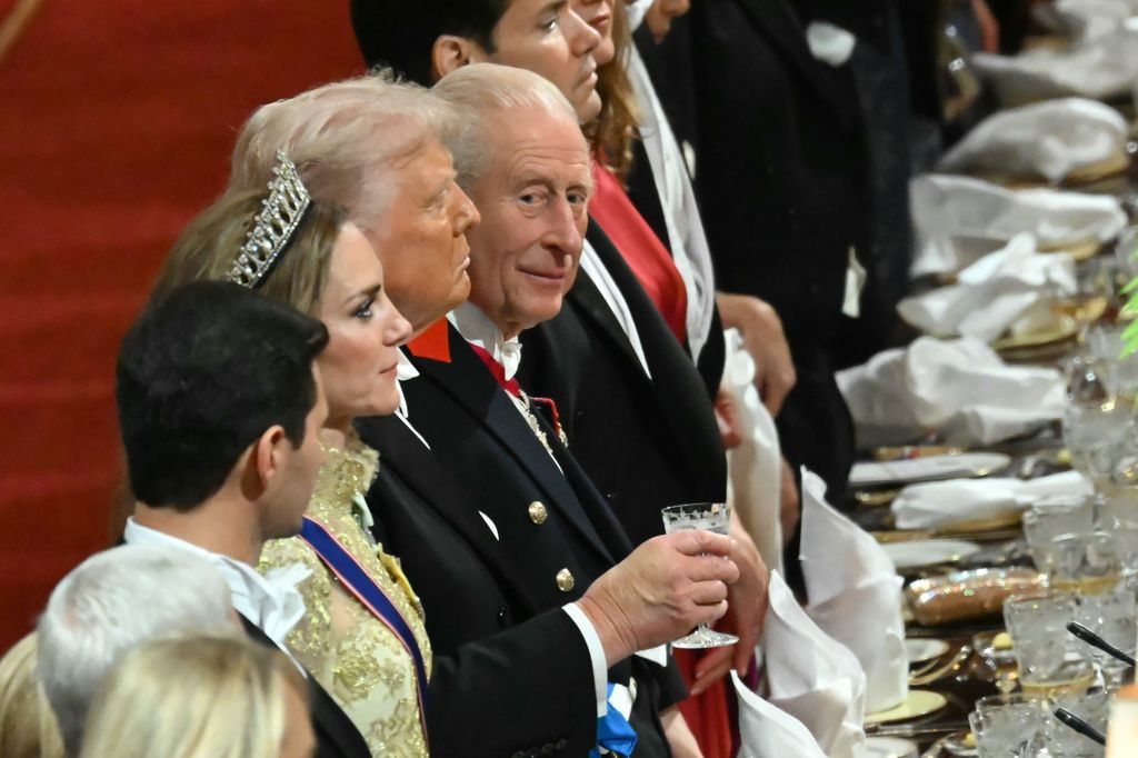 Britain's King Charles III (C) glances while standing beside US President Donald Trump during a State Banquet 