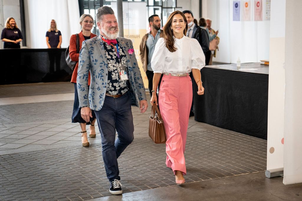 Crown Princess Mary wearing puff sleeve blouse and pink trousers
