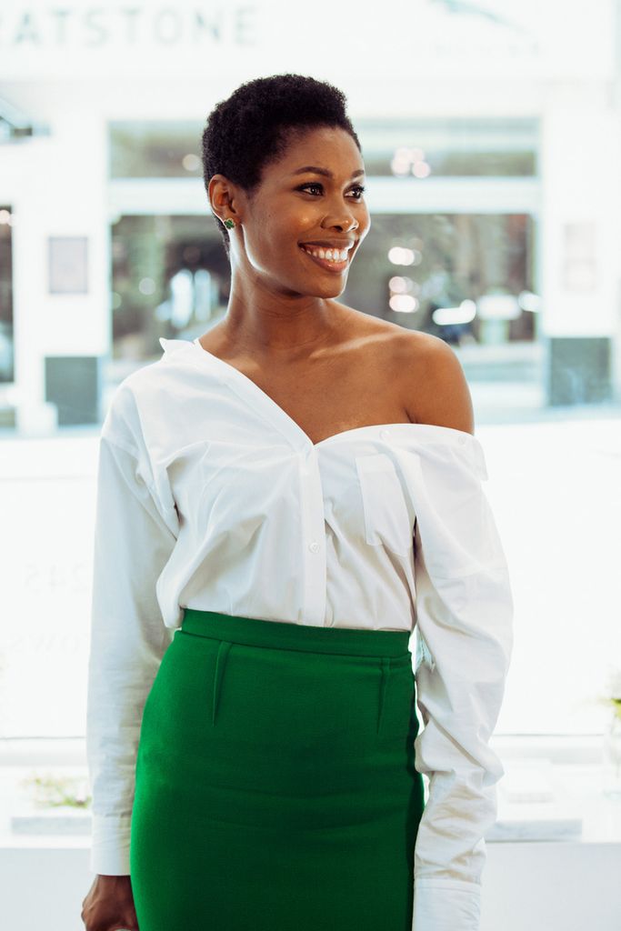 Woman in white off the shoulder top and green skirt