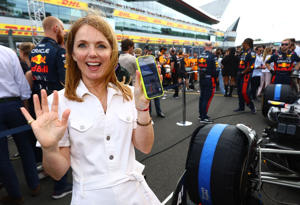 Geri Horner waving in a white button up jumpsuit