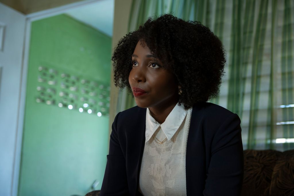 Woman in white shirt and black blazer, close-up