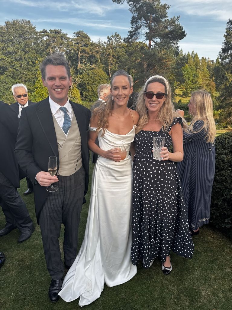 hum fleming in wedding dress flanked by man and woman