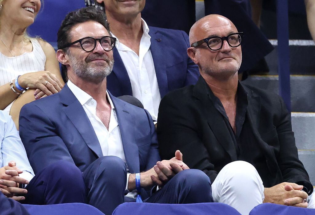 Hugh Jackman enjoys the match alongside a companion