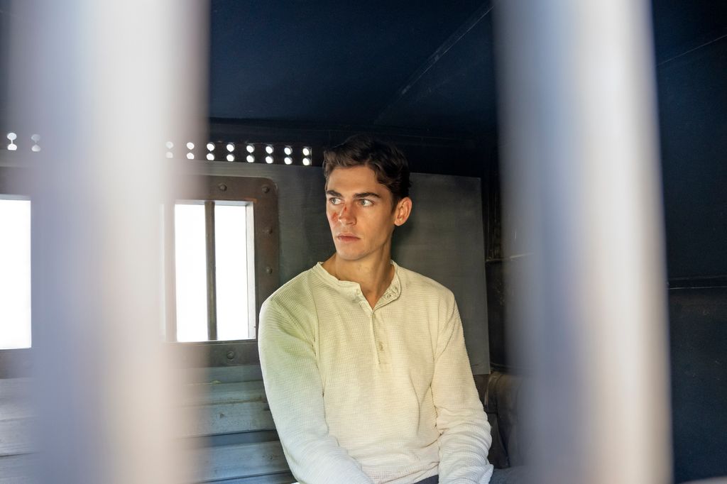 man sitting in jail car