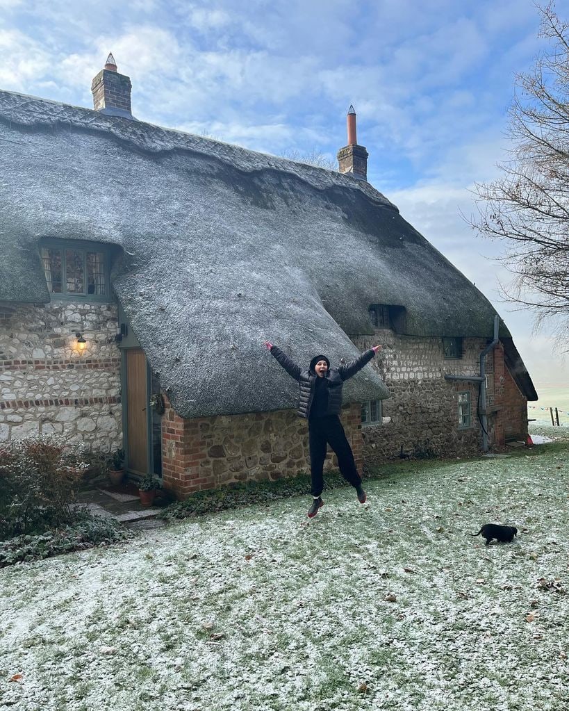 Sadie Frost outside a thatched cottage in the countryside