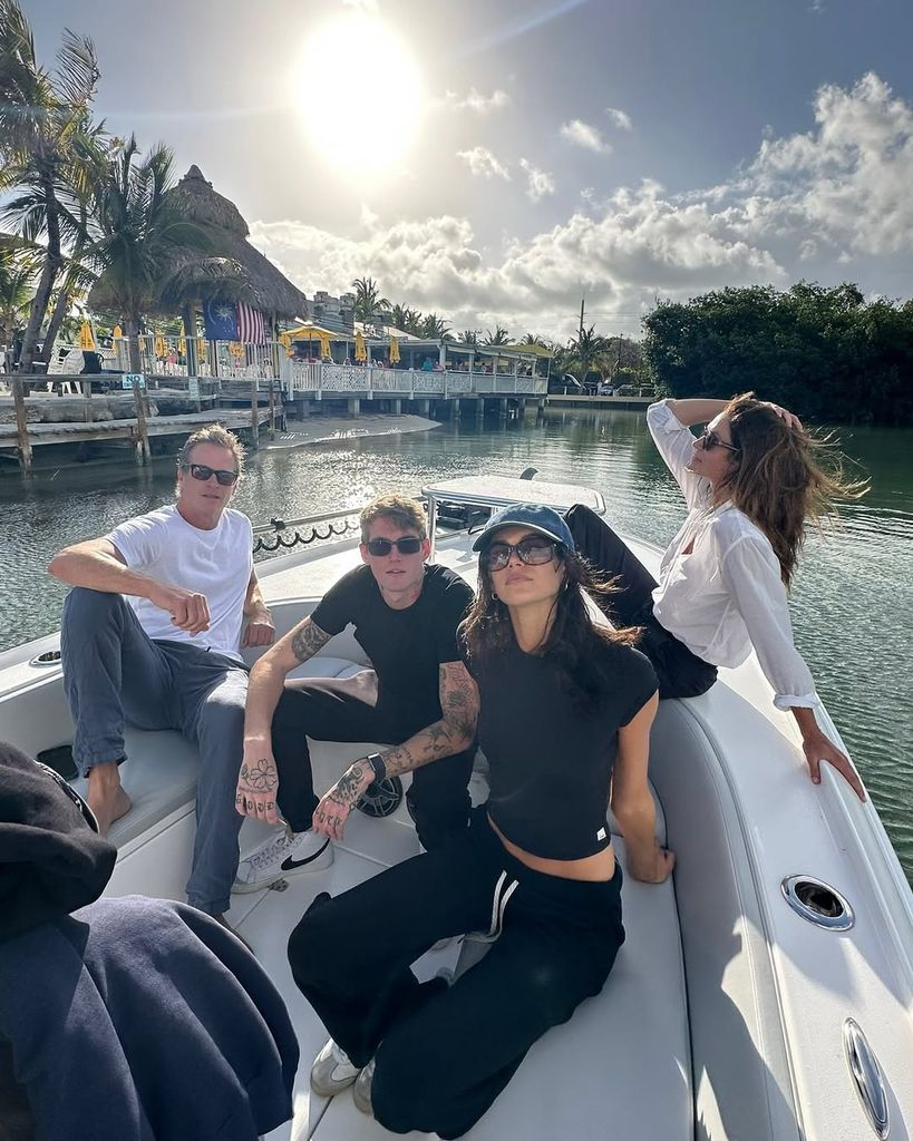 Cindy Crawford posing with her family on a boat
