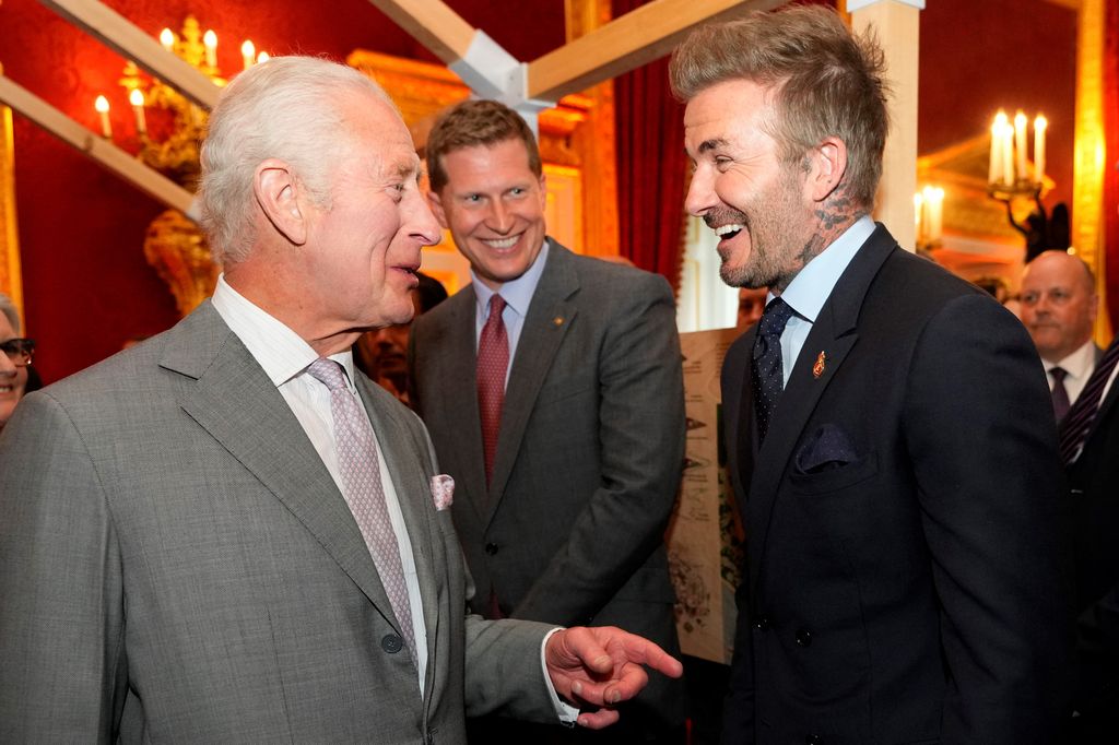 King Charles joking with David Beckham