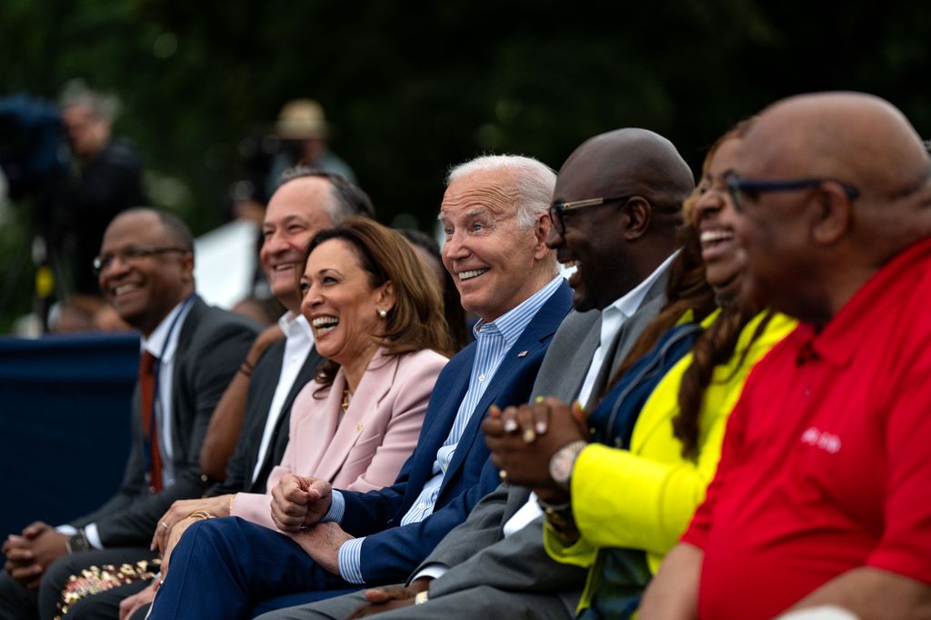 WASHINGTON, DC - JUNE 10: U.S. President Joe Biden (C), along with Second Gentleman Doug Emhoff (L) and Vice President Kamala Harris, attends a Juneteenth concert on the South Lawn of the White House on June 10, 2024 in Washington, DC. Biden In 2021 signed legislation establishing as a Federal holiday Juneteenth, which commemorates the ending of slavery in the United States.  (Photo by Kent Nishimura/Getty Images)