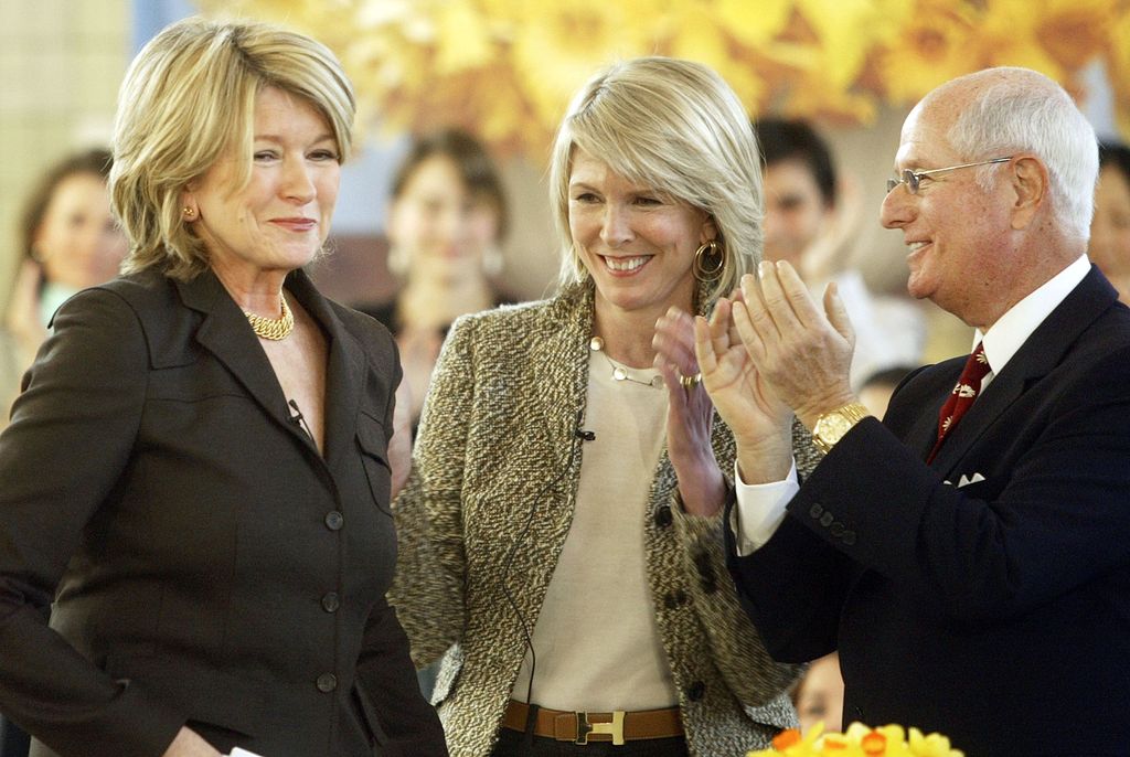 Martha Stewart (L) smiles as she is applauded by Susan Lyne, President and CEO (C) and Charles Koppleman, Vice-Chairman, both of Martha Stewart Living, prior to speaking to an audience of her employees and the media on her first day back to her offices since her incarceration March 7, 2005 in New York City.