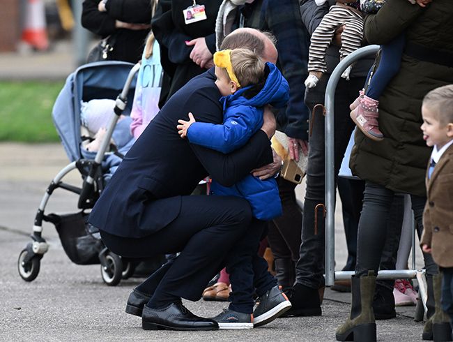 Prince William hugs a child