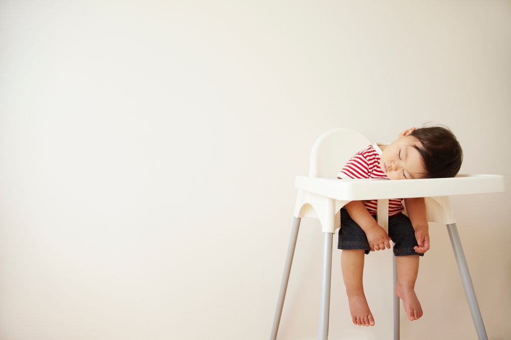 baby sleeping in highchair