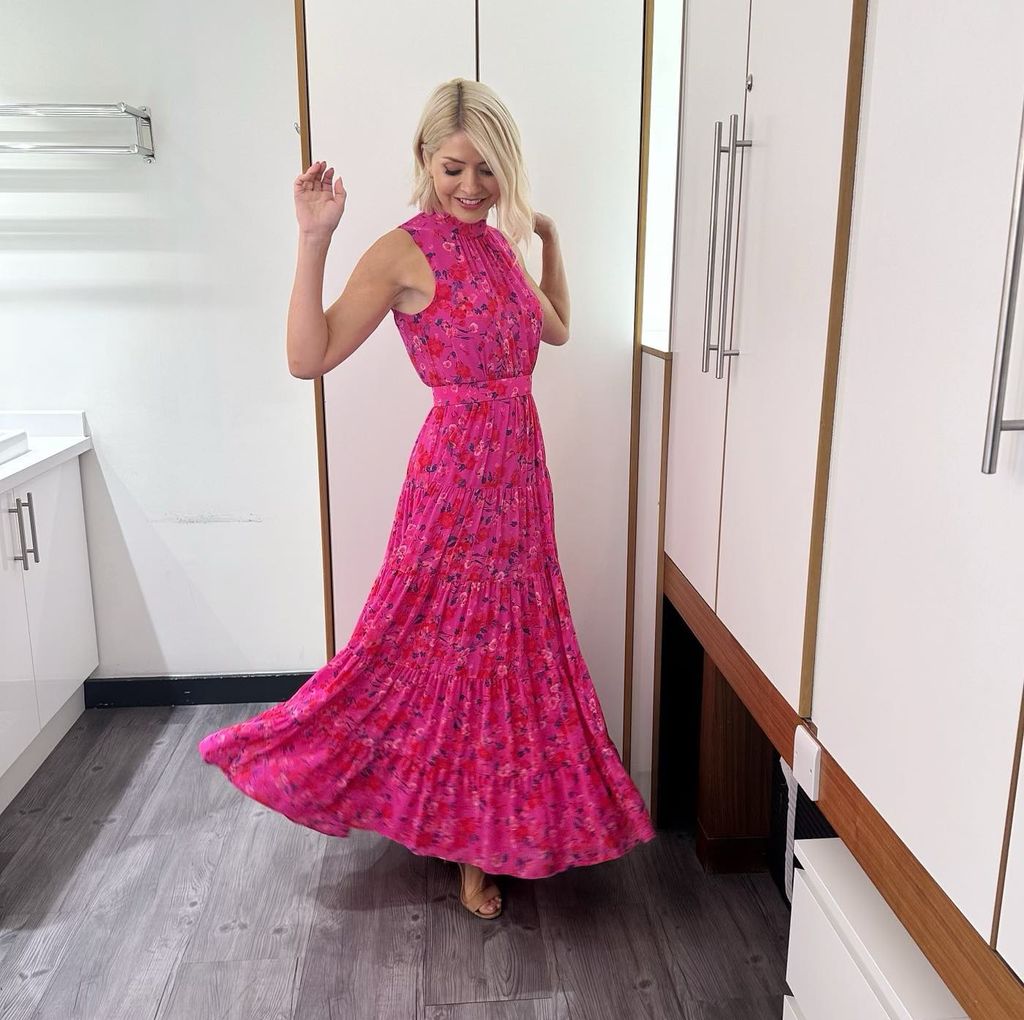 Holly Willoughby twirling in hot pink sleeveless floral dress