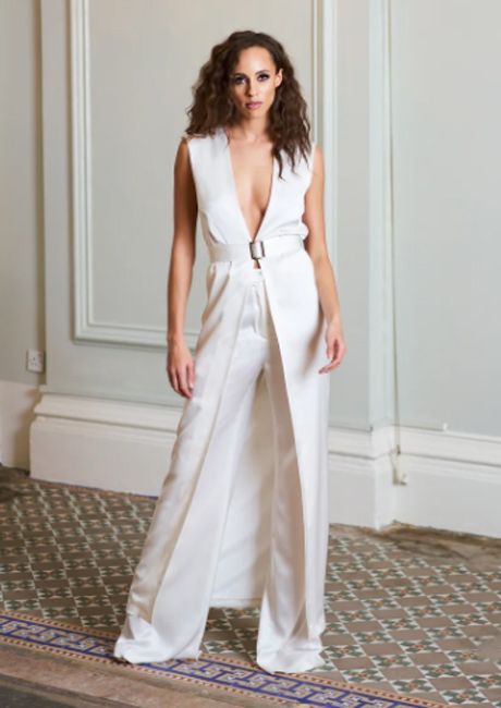 model wears ivory satin duster jacket over trousers