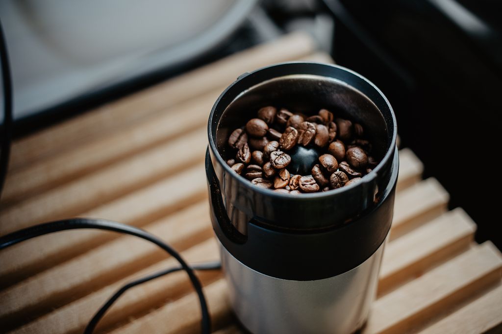 electric coffee grinder filled with coffee beans