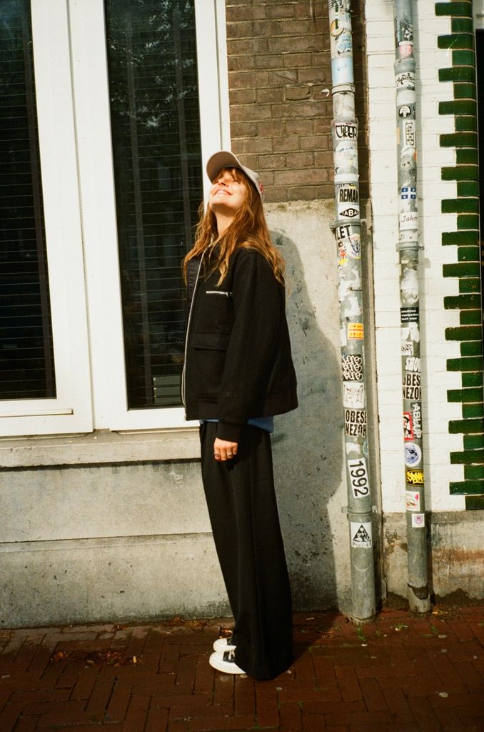 rosie viva in jacket and cap and sneakers