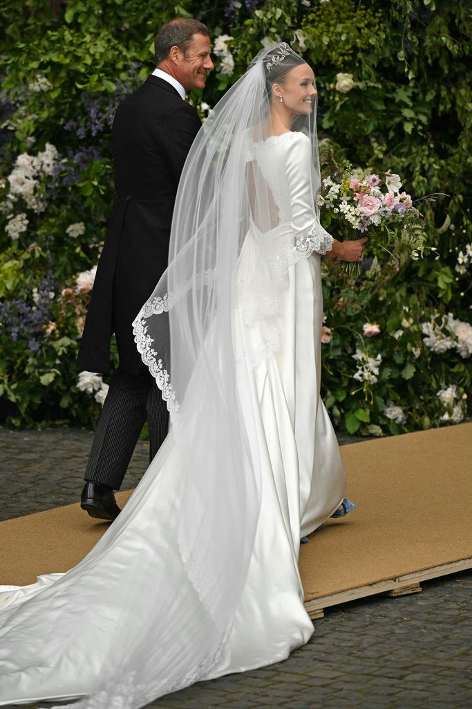 
Bride Olivia Henson arrived at the cathedral wearing a dress and veil designed by Emma Victoria Payne