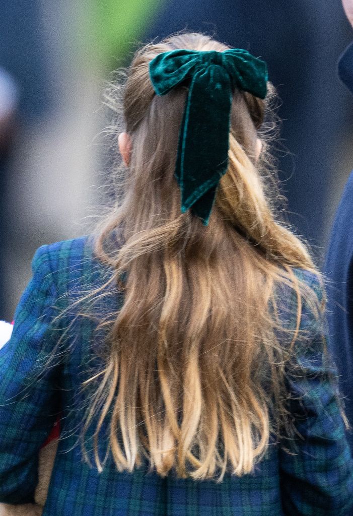 Princess Charlotte from back with green hair bow