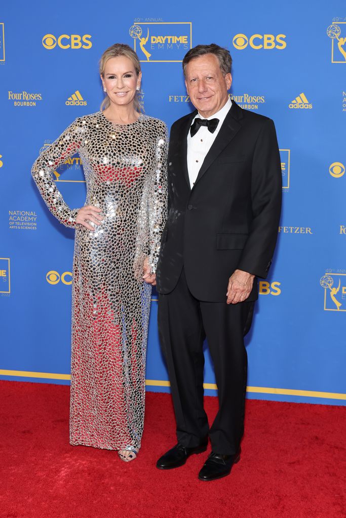 Dr. Jennifer Ashton and Tom Werner smiling on a red carpet