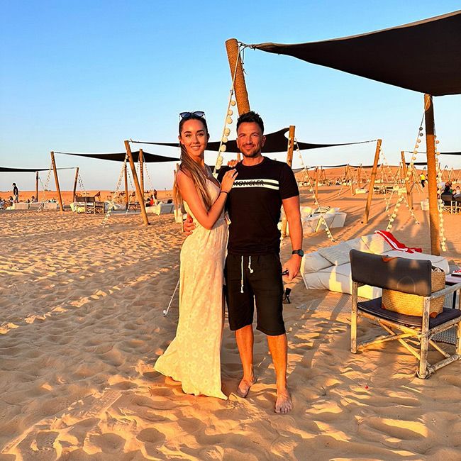 Peter Andre and Emily posing in a beach in Dubai
