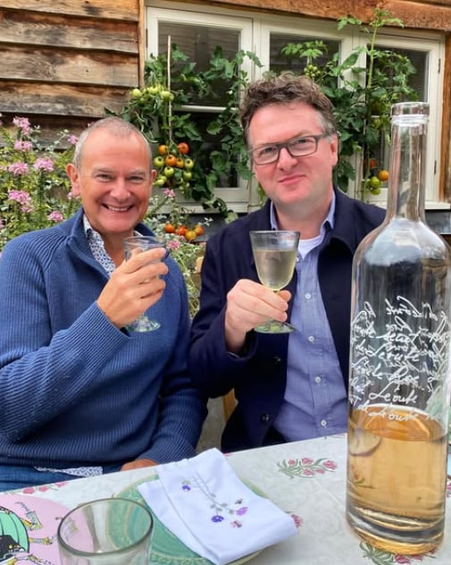 Hugh and his friend drinking wine in garden