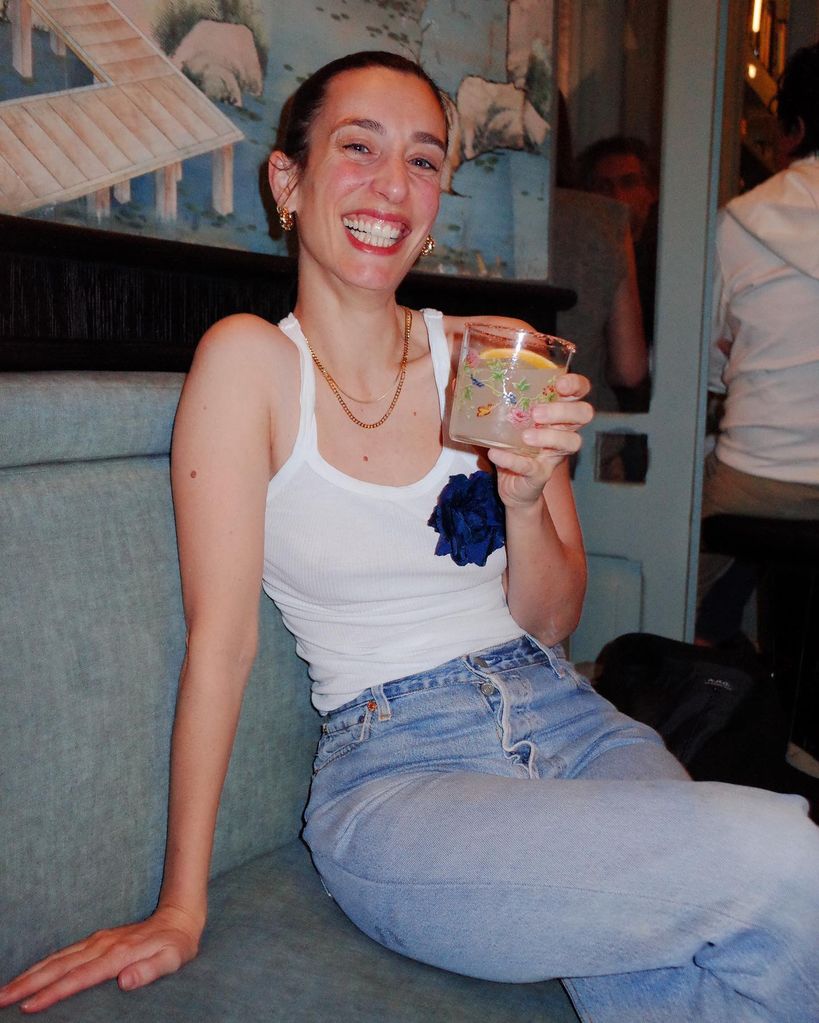 Laura smiling holding drink