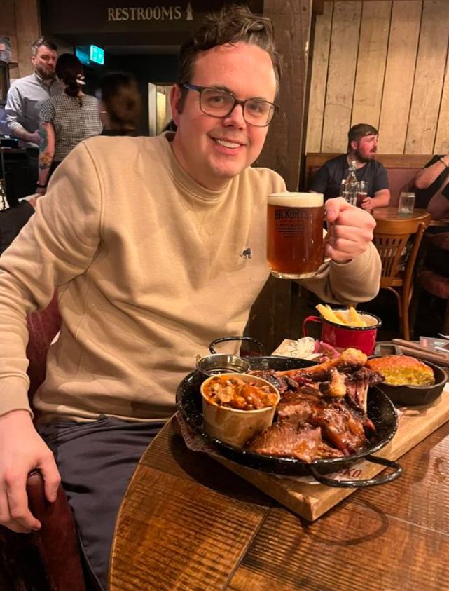 A man holding a tankard of beer