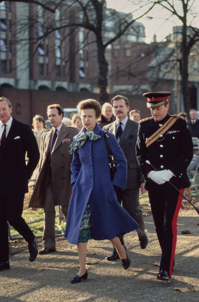 Princess Anne walking with Andrew Parker Bowles in a ceremonial uniform
