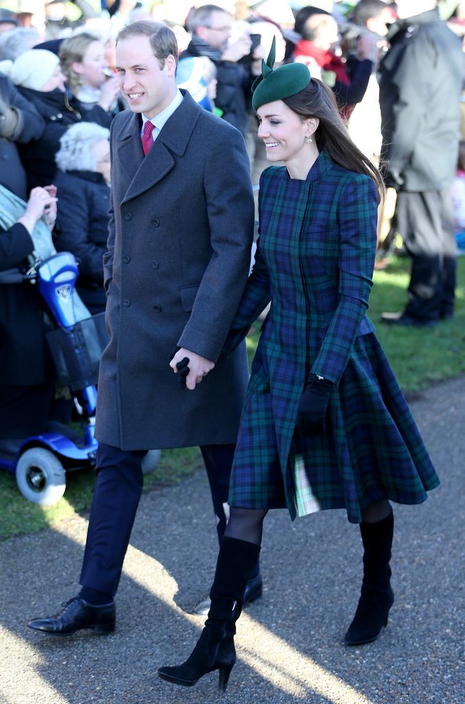 Prince William in suit walking with kate in tartan dress