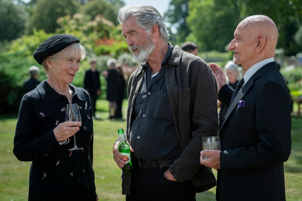 Celia Imrie, Pierce Brosnan and Ben Kingsley filming The Thursday Murder Club funeral scene in outdoor setting