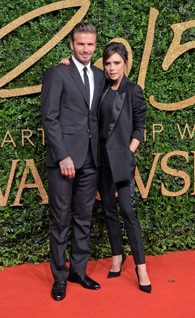 David Beckham and Victoria Beckham on red carpet in black suits