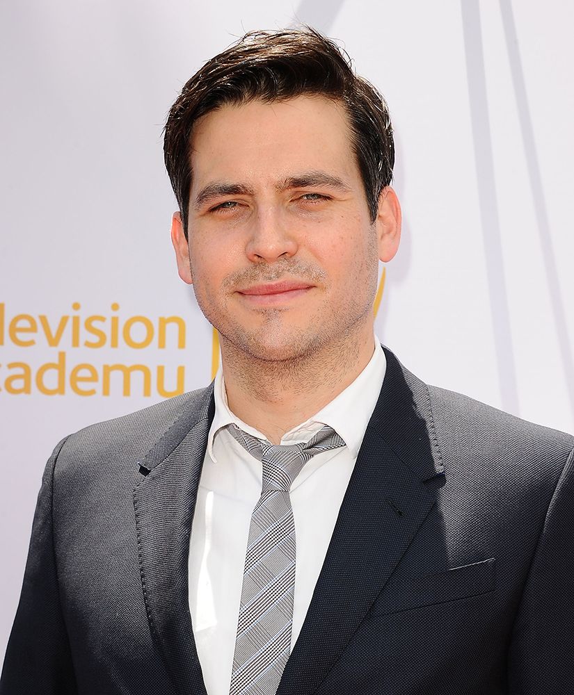 Actor Rob James-Collier at an afternoon with Downton Abbey event in 2014. He is wearing a black suit, white shirt and grey tie. 