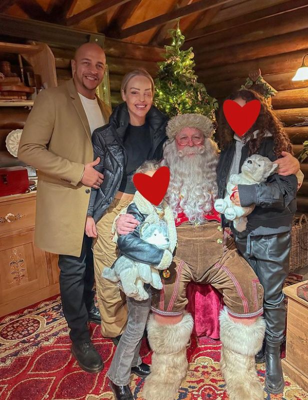 Richard Sutton and Katie Piper in a Santa's Grotto with their two children