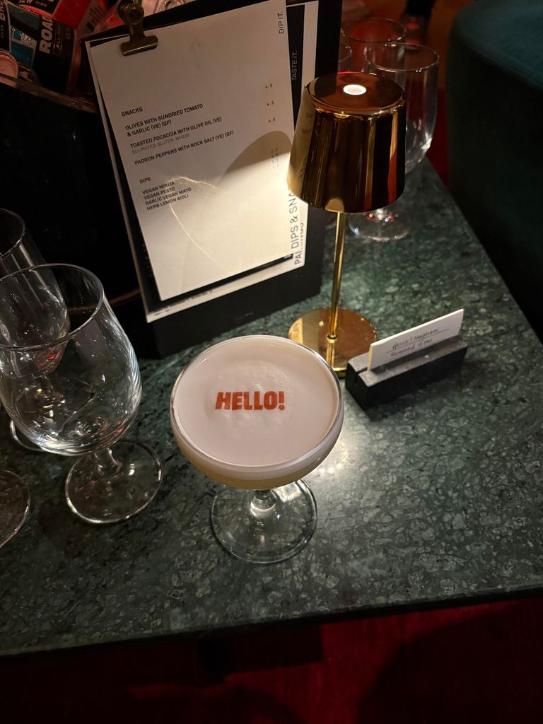 A passionfruit martini with the HELLO! logo on top