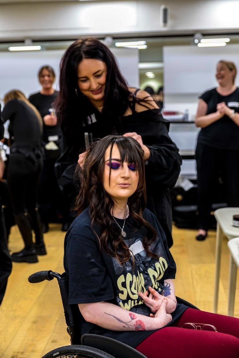 Young woman having her hair and makeup done