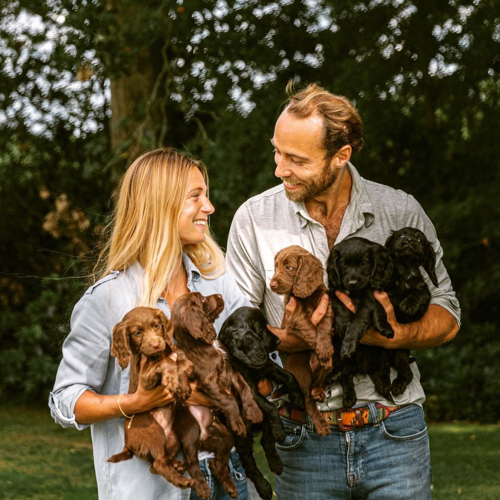 Alizee and James holding cocker spaniel puppies