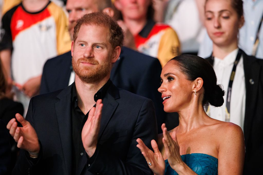 Harry and Meghan clapping at Invictus Games 2023