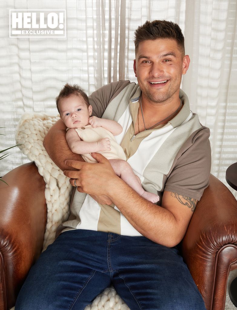 Aljaz Skorjanec wears jumper as he cradles baby Lyra