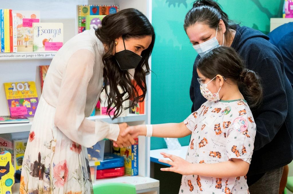 Meghan Markle shaking young patient's hand