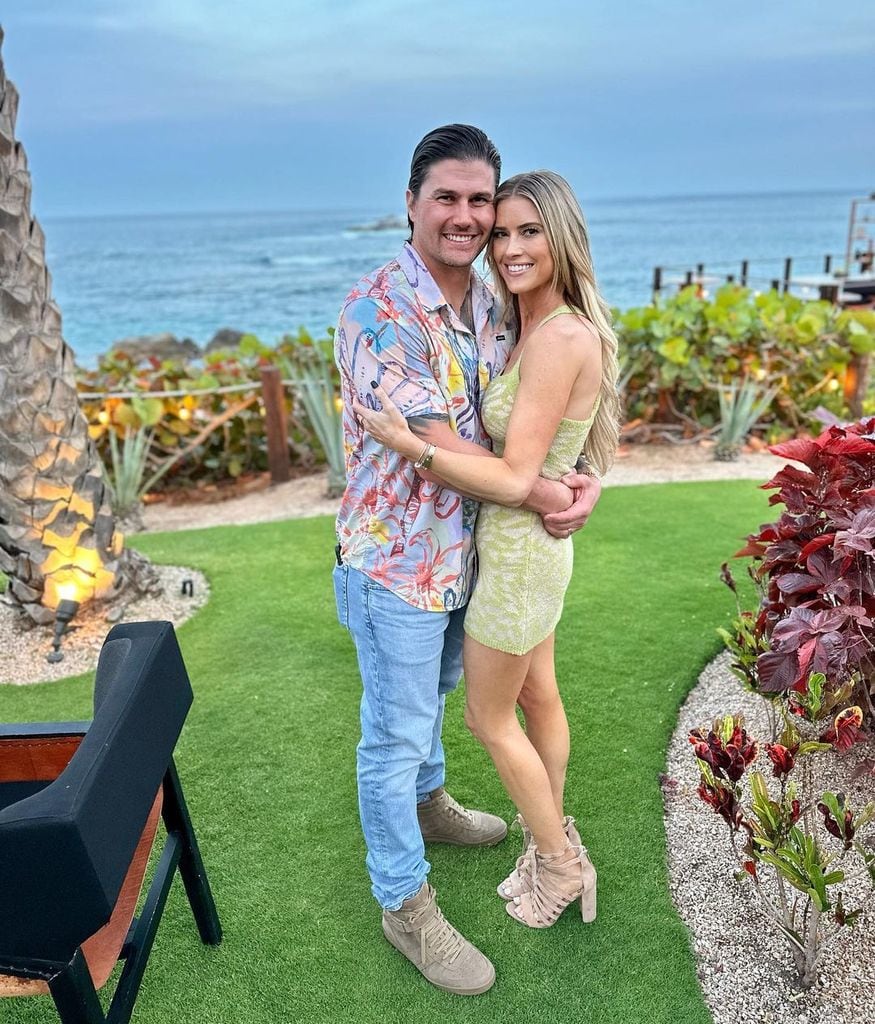 Christina Hall hugs her husband Josh Hall on vacation in Mexico