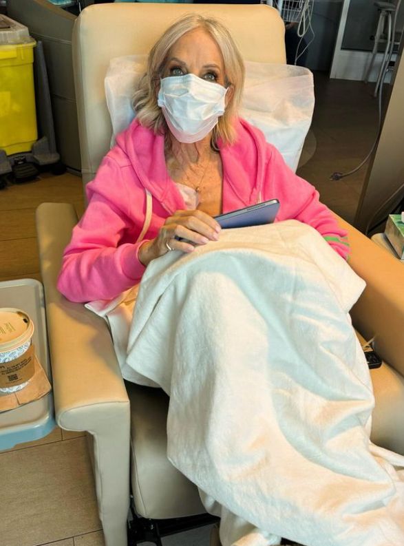 An elderly woman in a hospital with a facemask